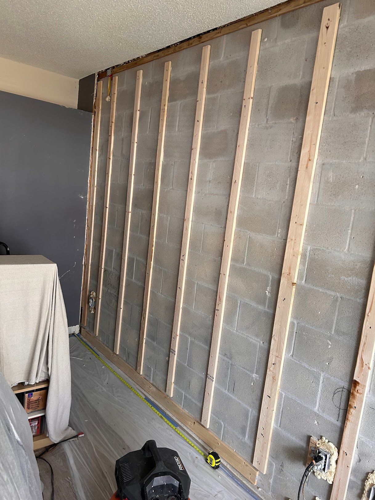 A room with a brick wall and wooden beams.