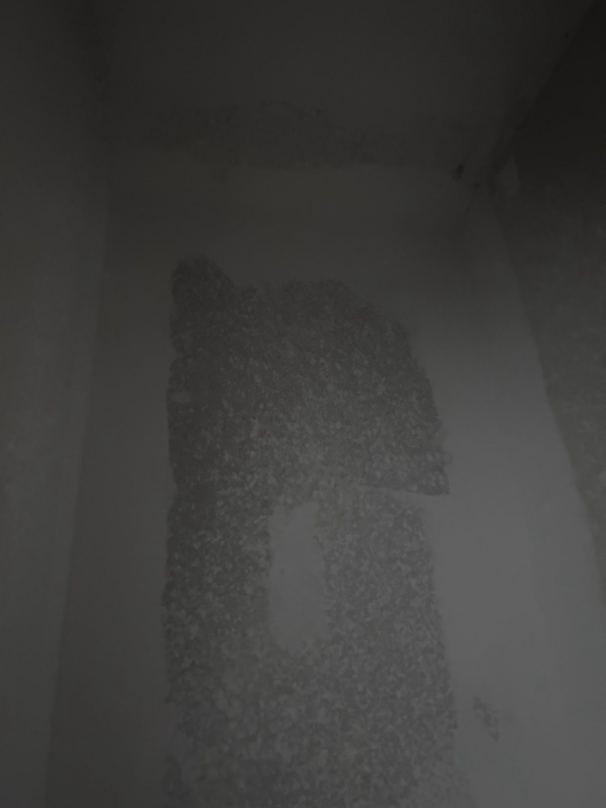 A black and white photo of a person 's shadow on a wall.