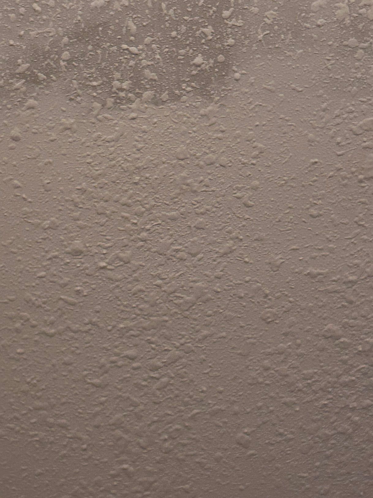 A close up of a brown wall with a lot of bubbles on it.