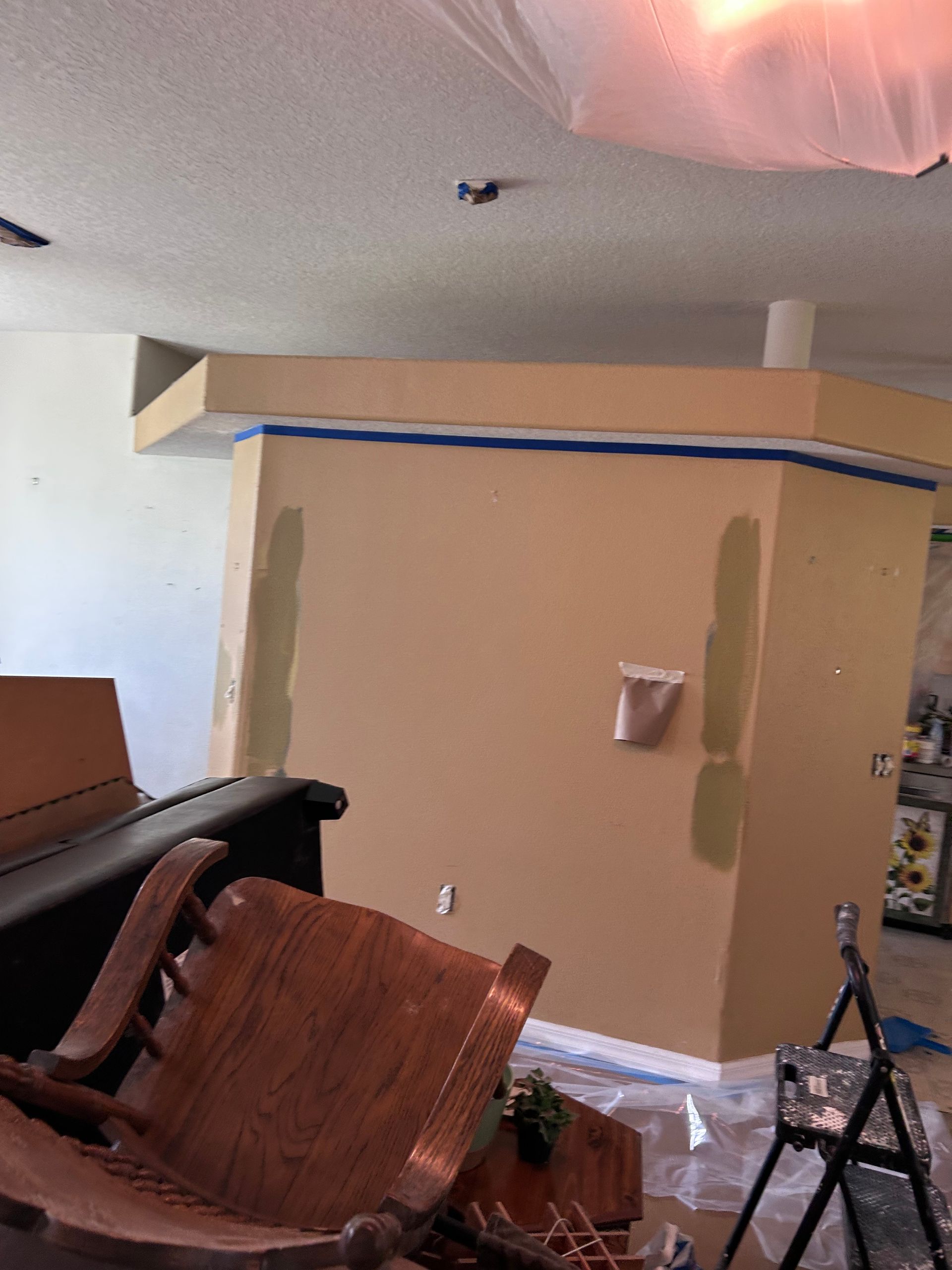 A room with a chair and a piano in it