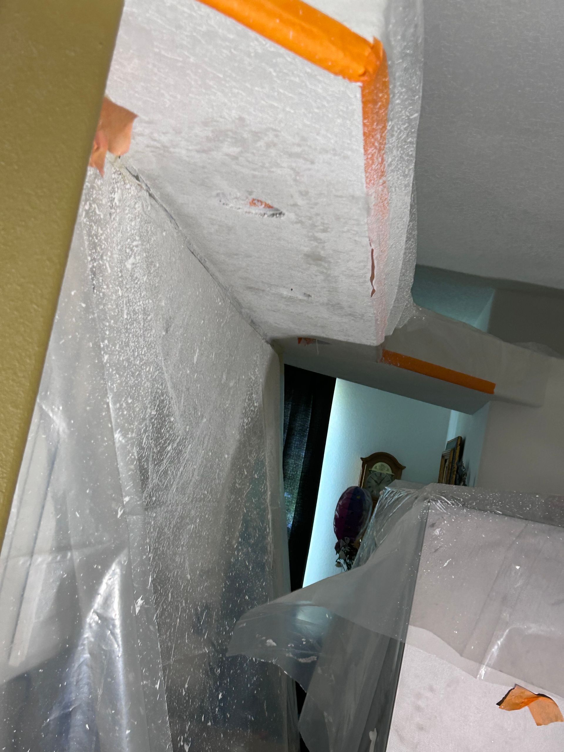 A piece of styrofoam is wrapped in plastic in a room