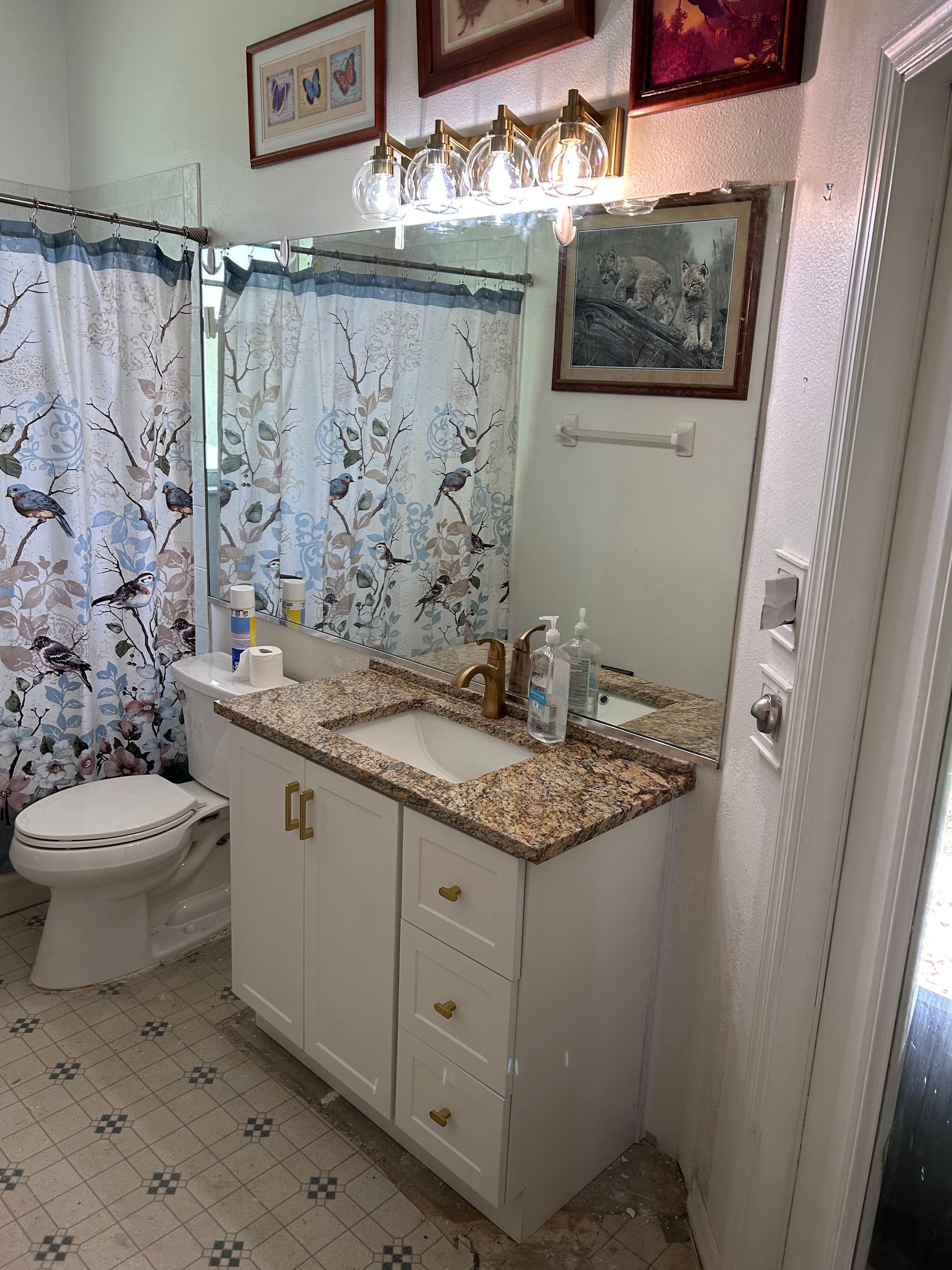 A bathroom with a sink , toilet , and mirror