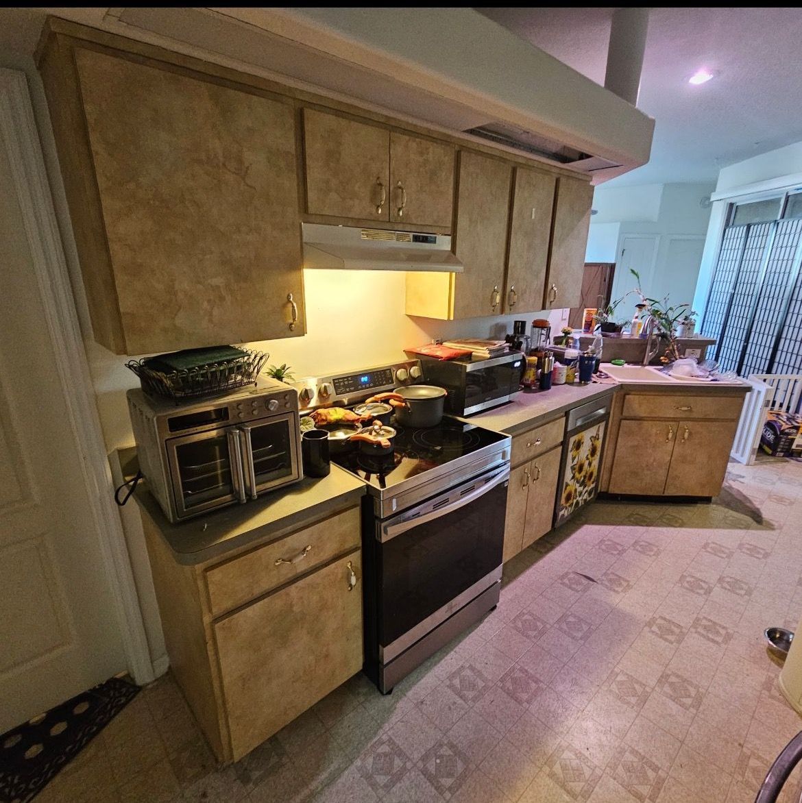 A kitchen with a stove , microwave , and oven.