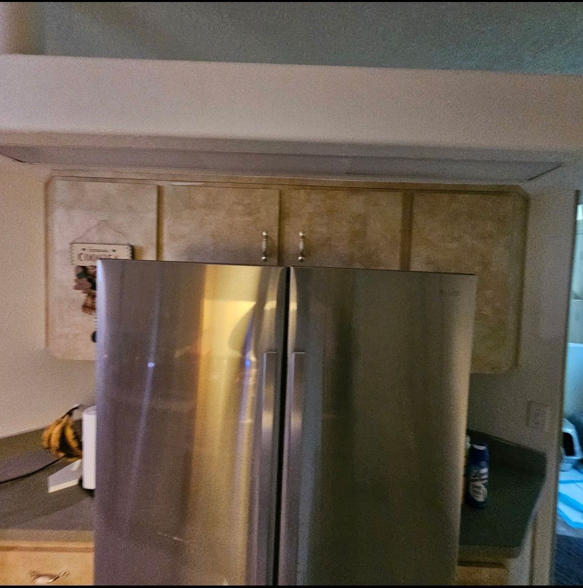 A stainless steel refrigerator is open in a kitchen