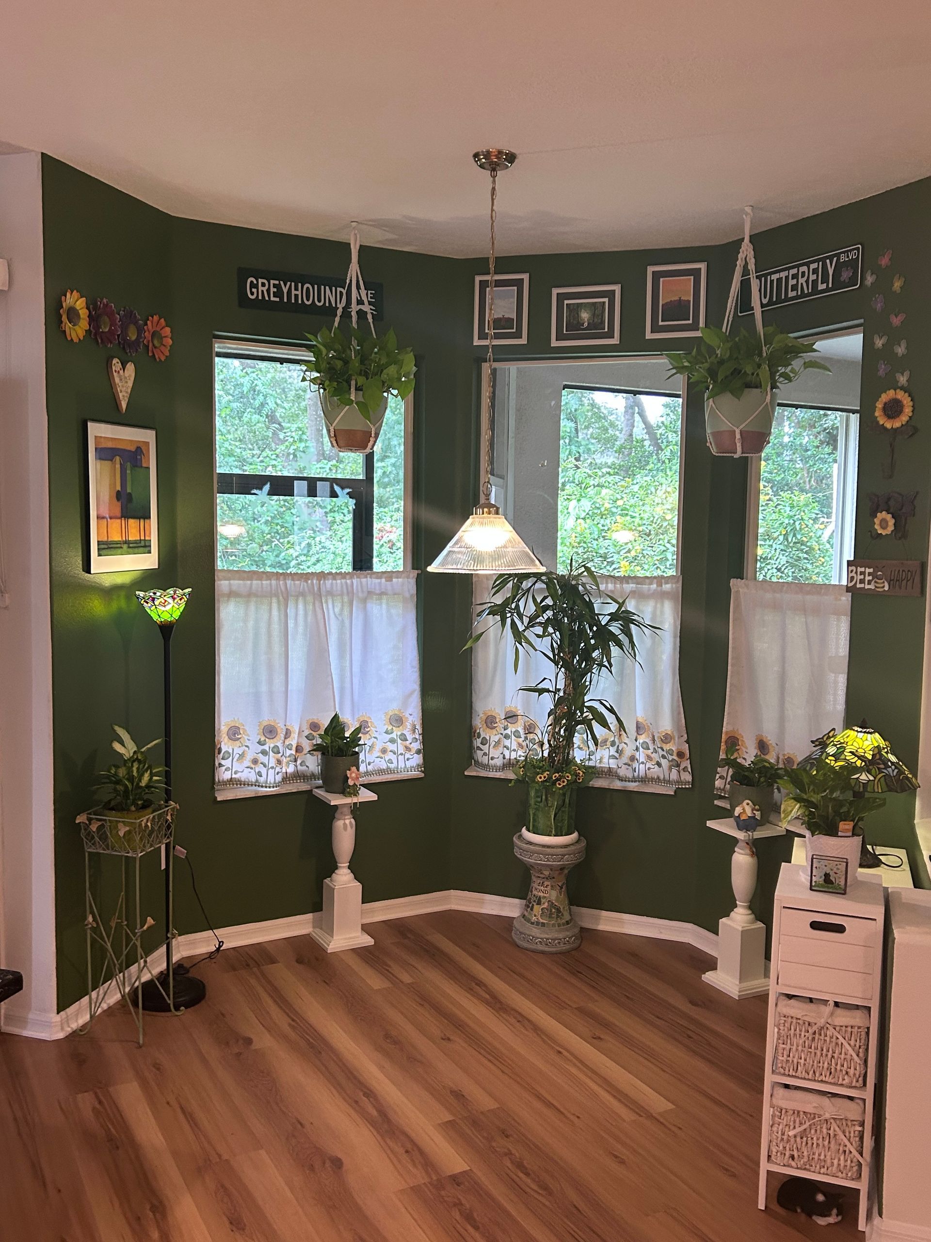 A living room with green walls and a wooden floor.