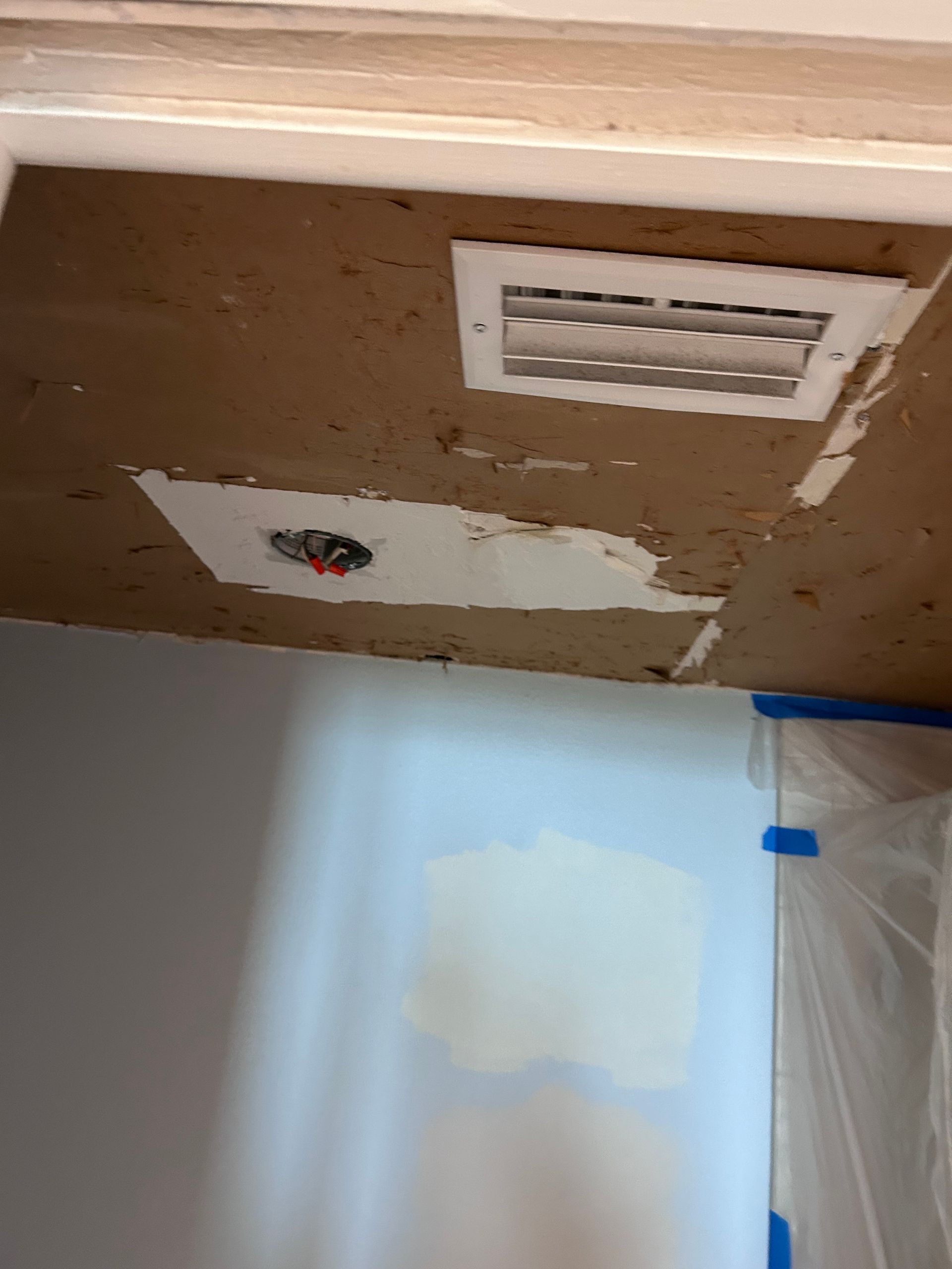 Ceiling with vent and exposed wiring, drywall repair in progress.