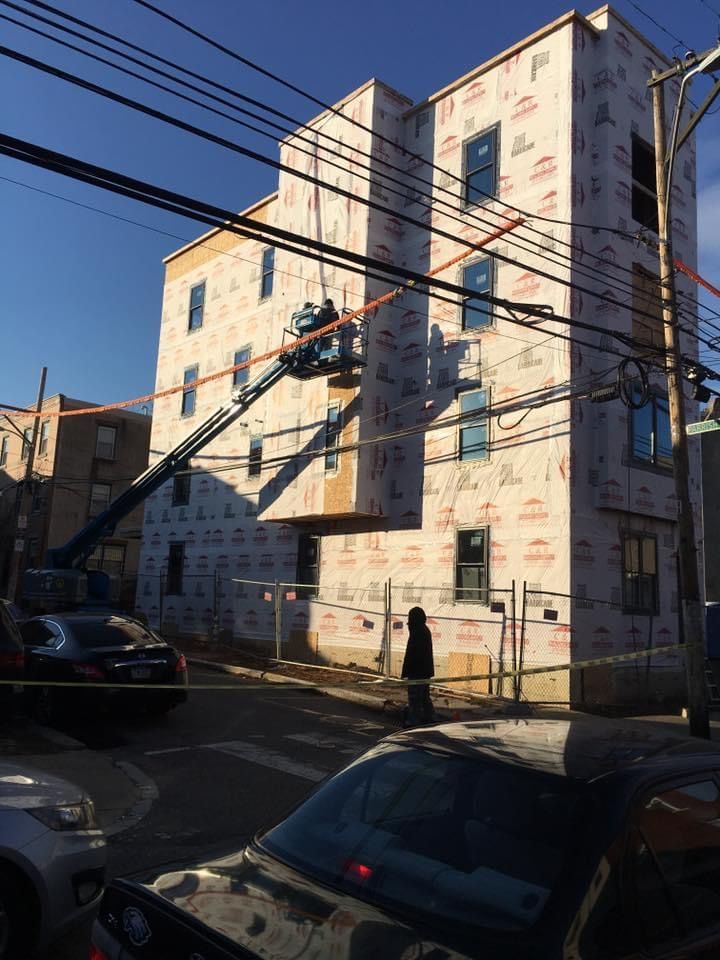 A building under construction with a crane on top of it