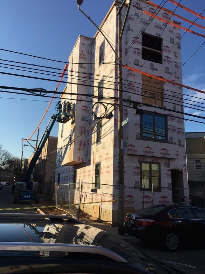 A building under construction with a crane on top of it