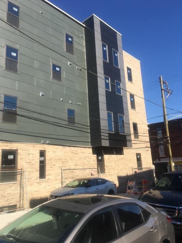 A building with a lot of windows and a car parked in front of it