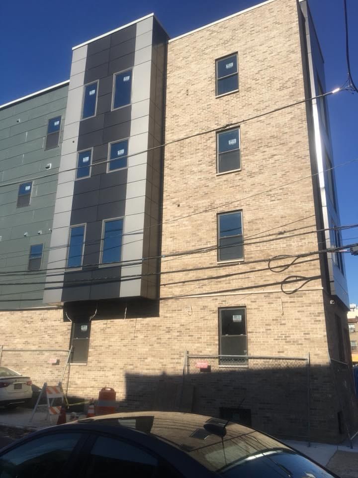 A building with a lot of windows and a car parked in front of it