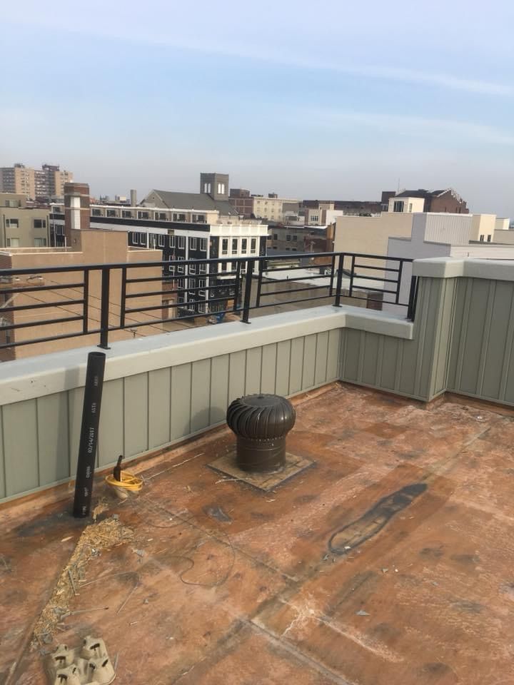 A rooftop with a view of a city and buildings
