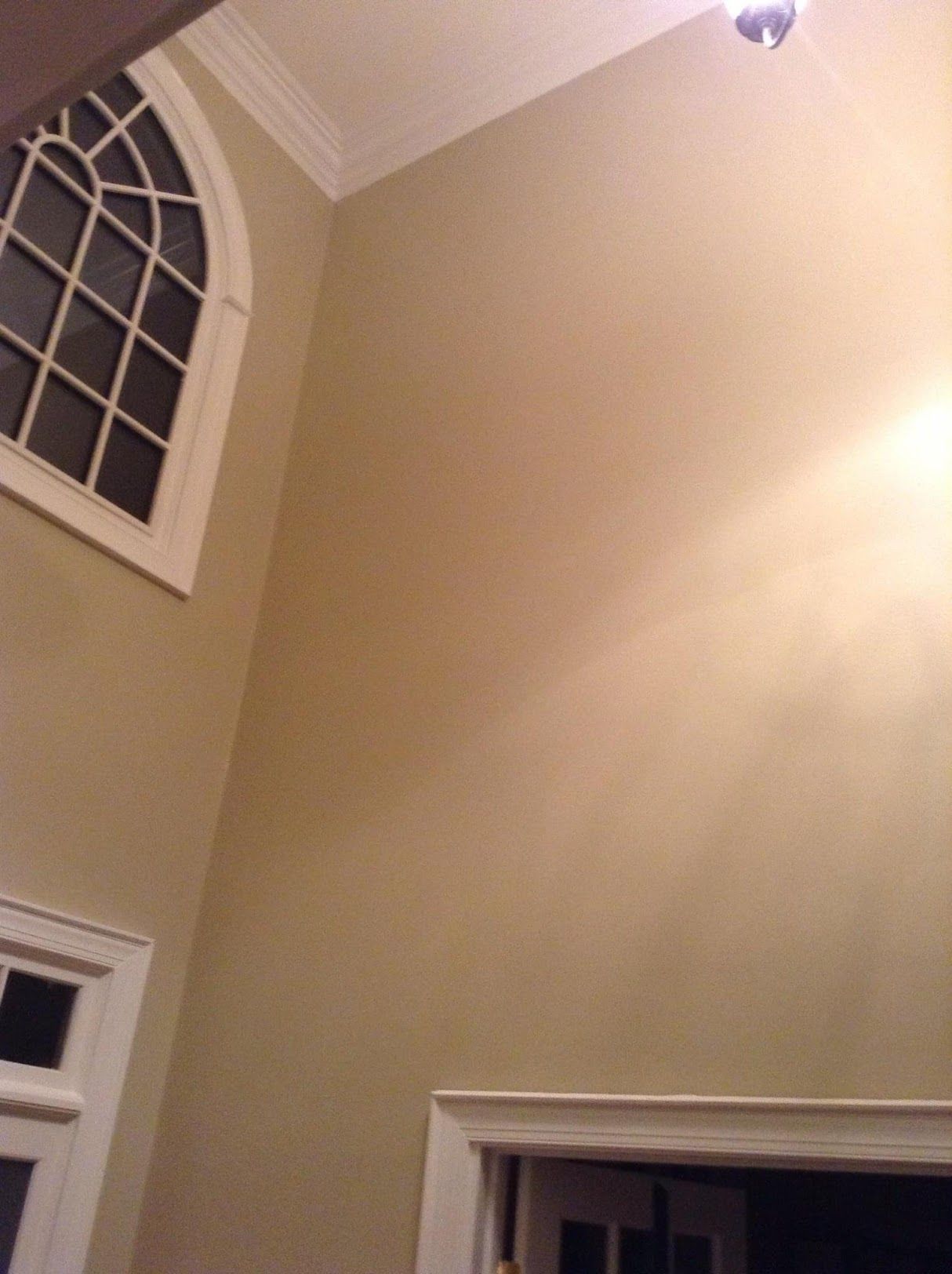 Looking up at the ceiling of a room with a window.