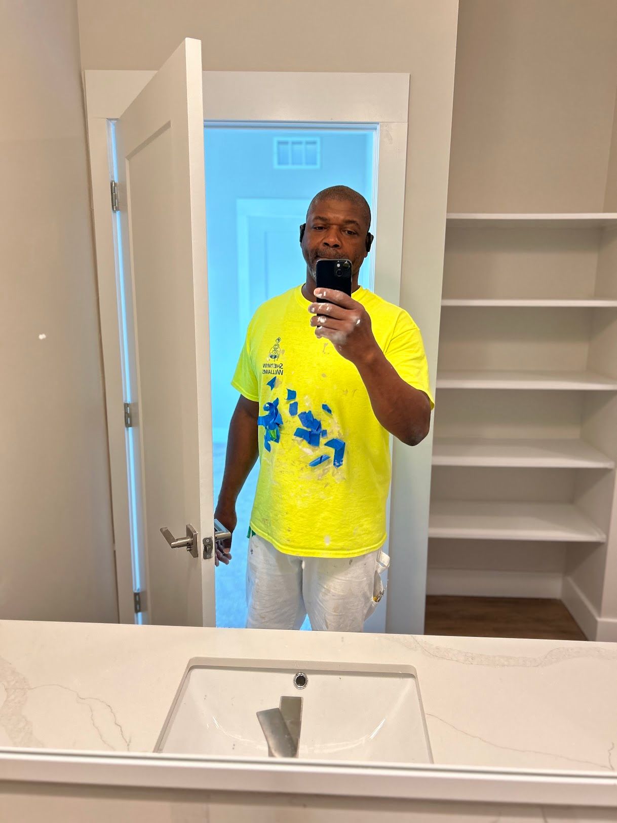 A man is taking a picture of himself in a bathroom mirror.