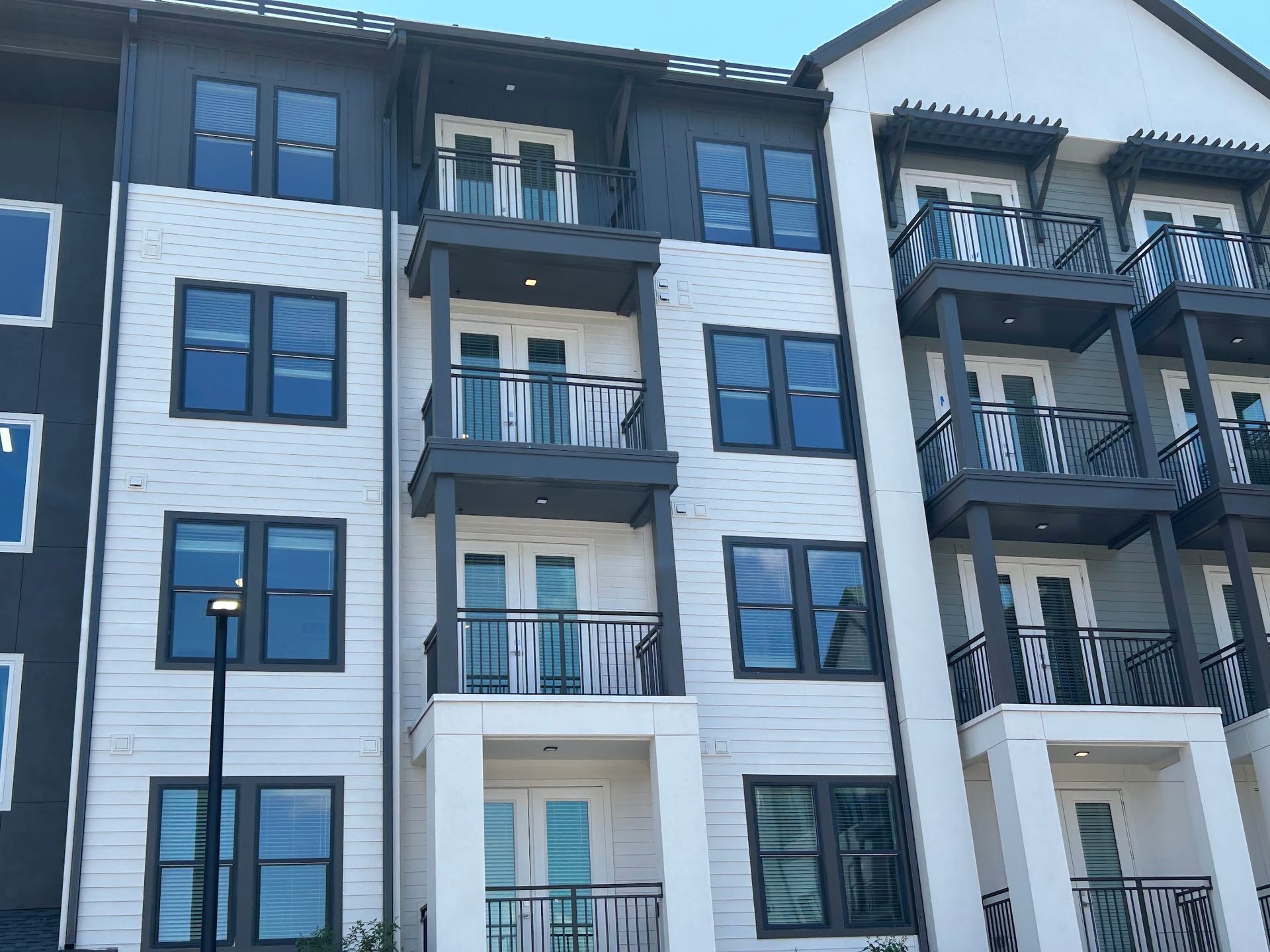 A large apartment building with a lot of windows and balconies.