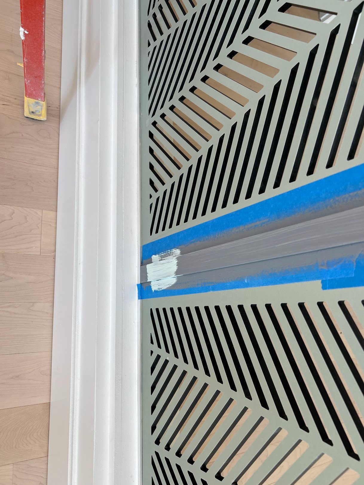 A close up of a door with a blue tape on it.