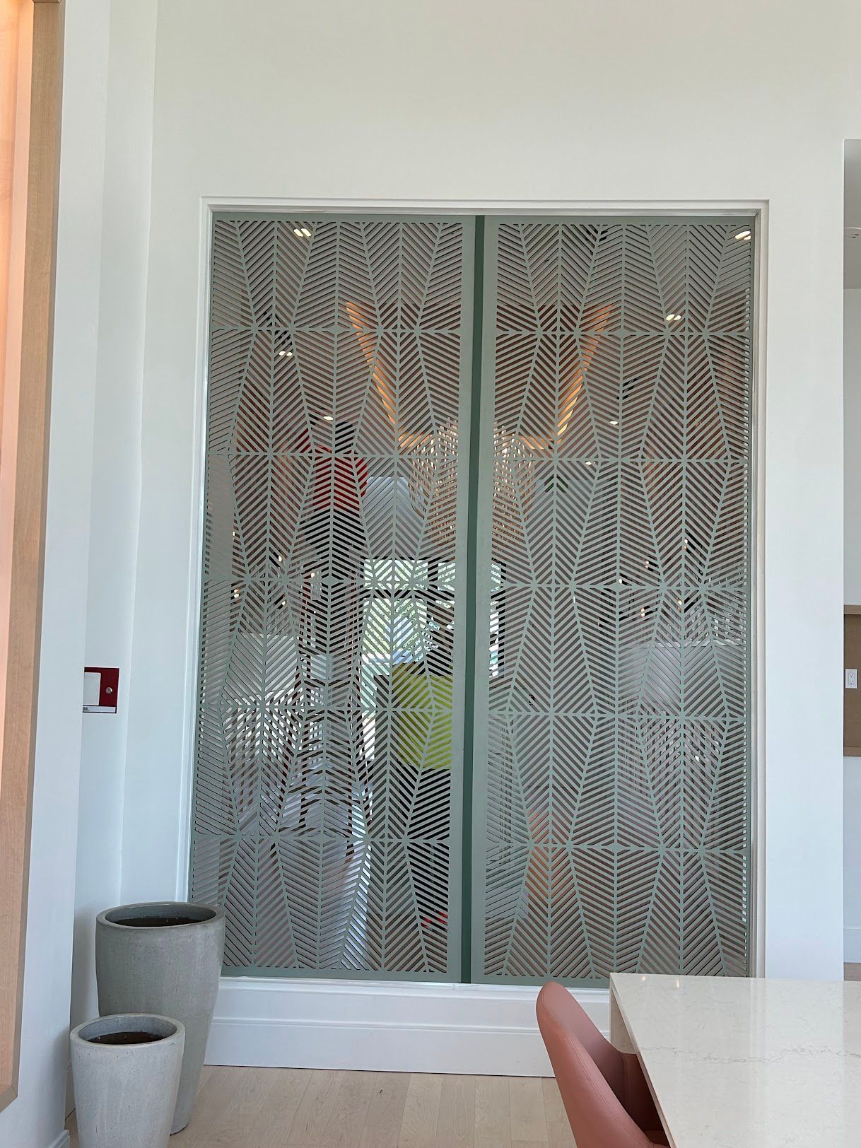 A room with a table and chairs and a fire extinguisher on the wall