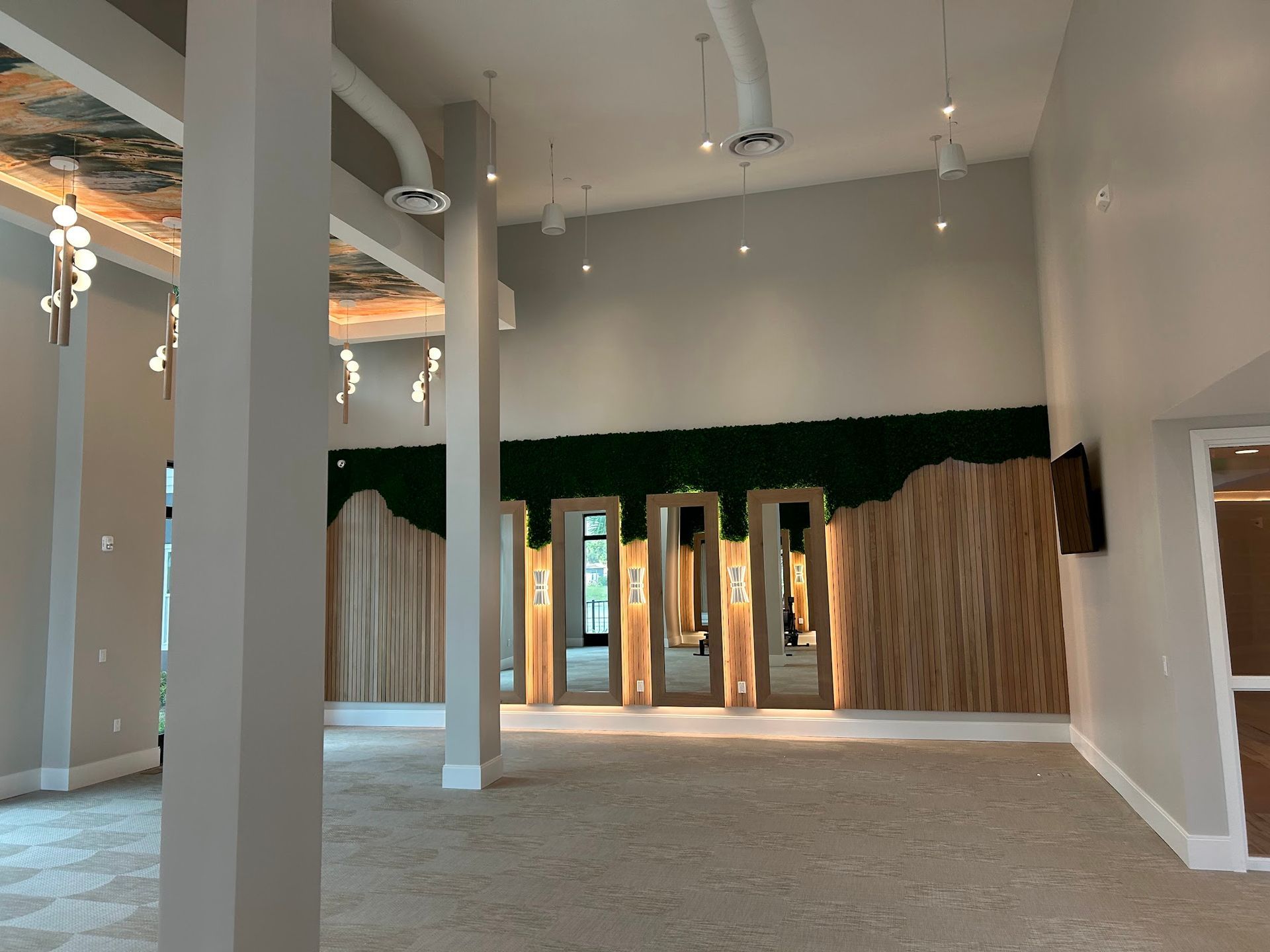 A large room with a lot of mirrors on the wall.