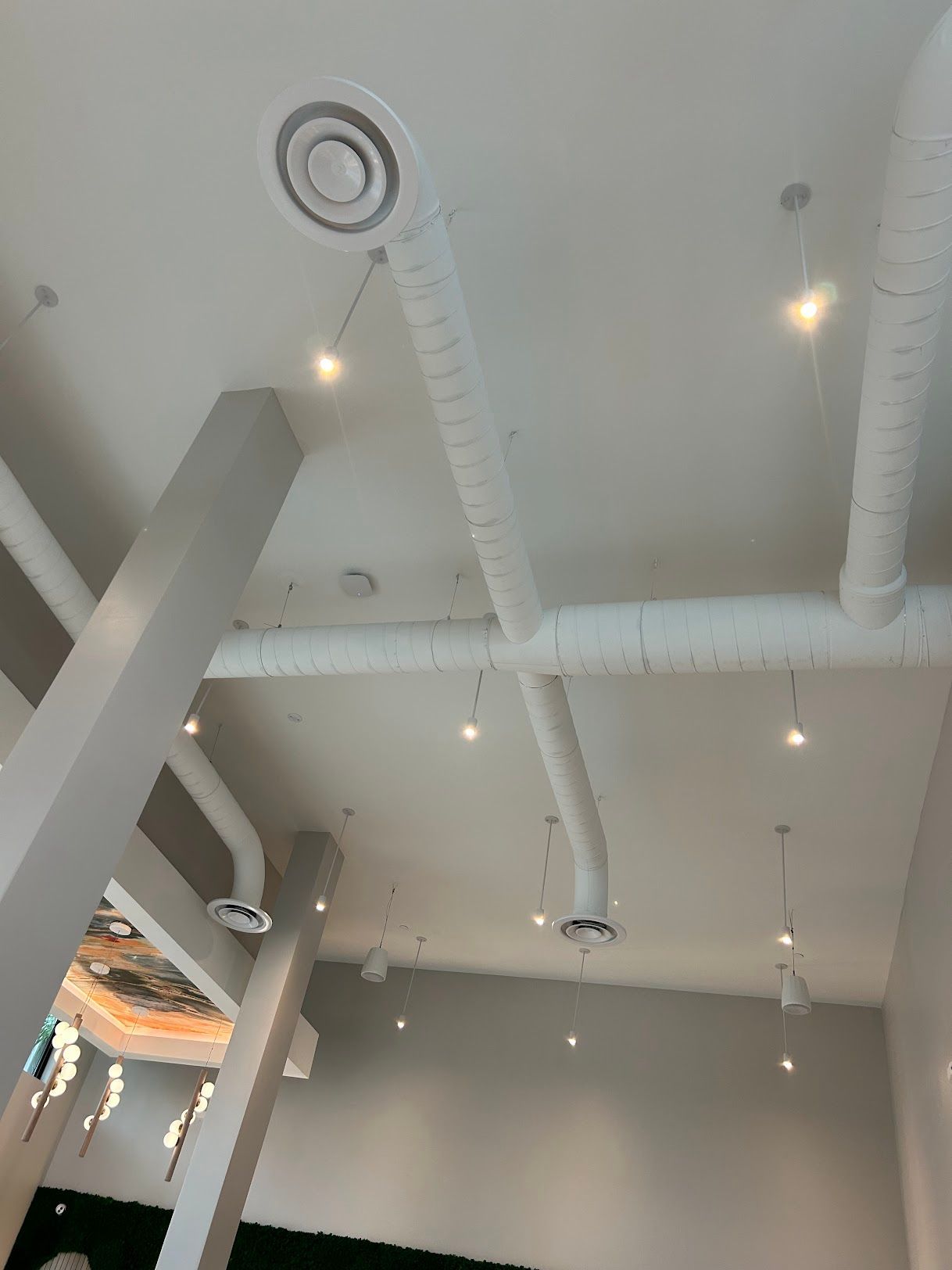A ceiling with a lot of pipes hanging from it