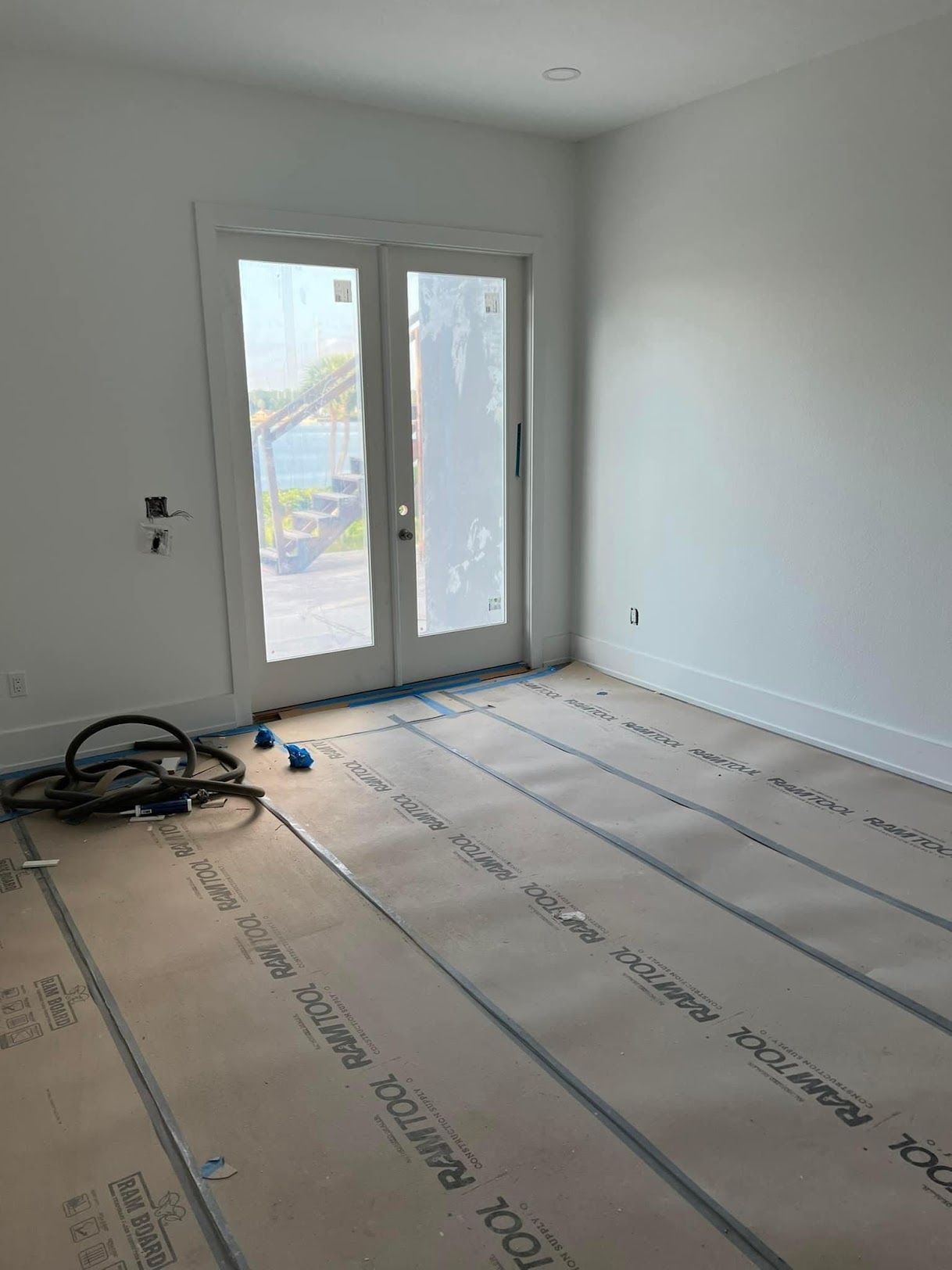 A room with a sliding glass door and a carpeted floor.