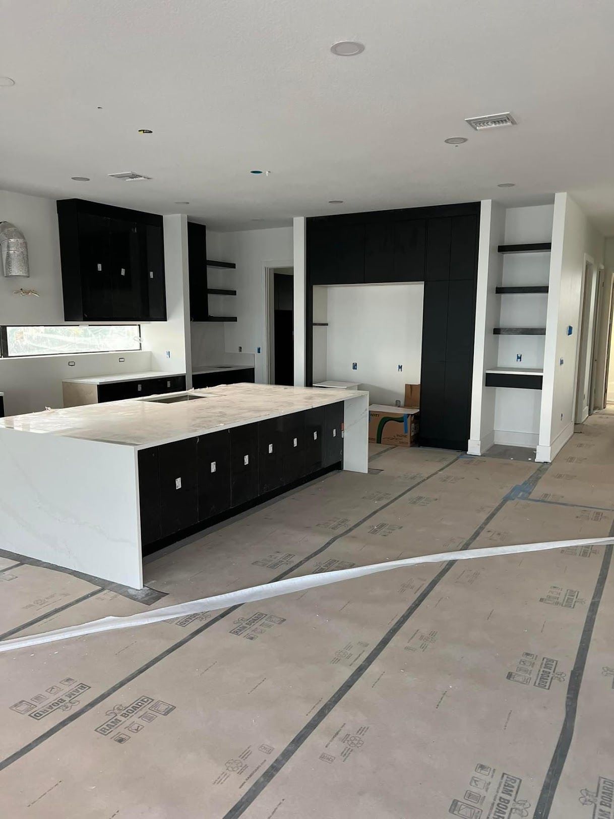 A kitchen under construction with a large island in the middle of the room.