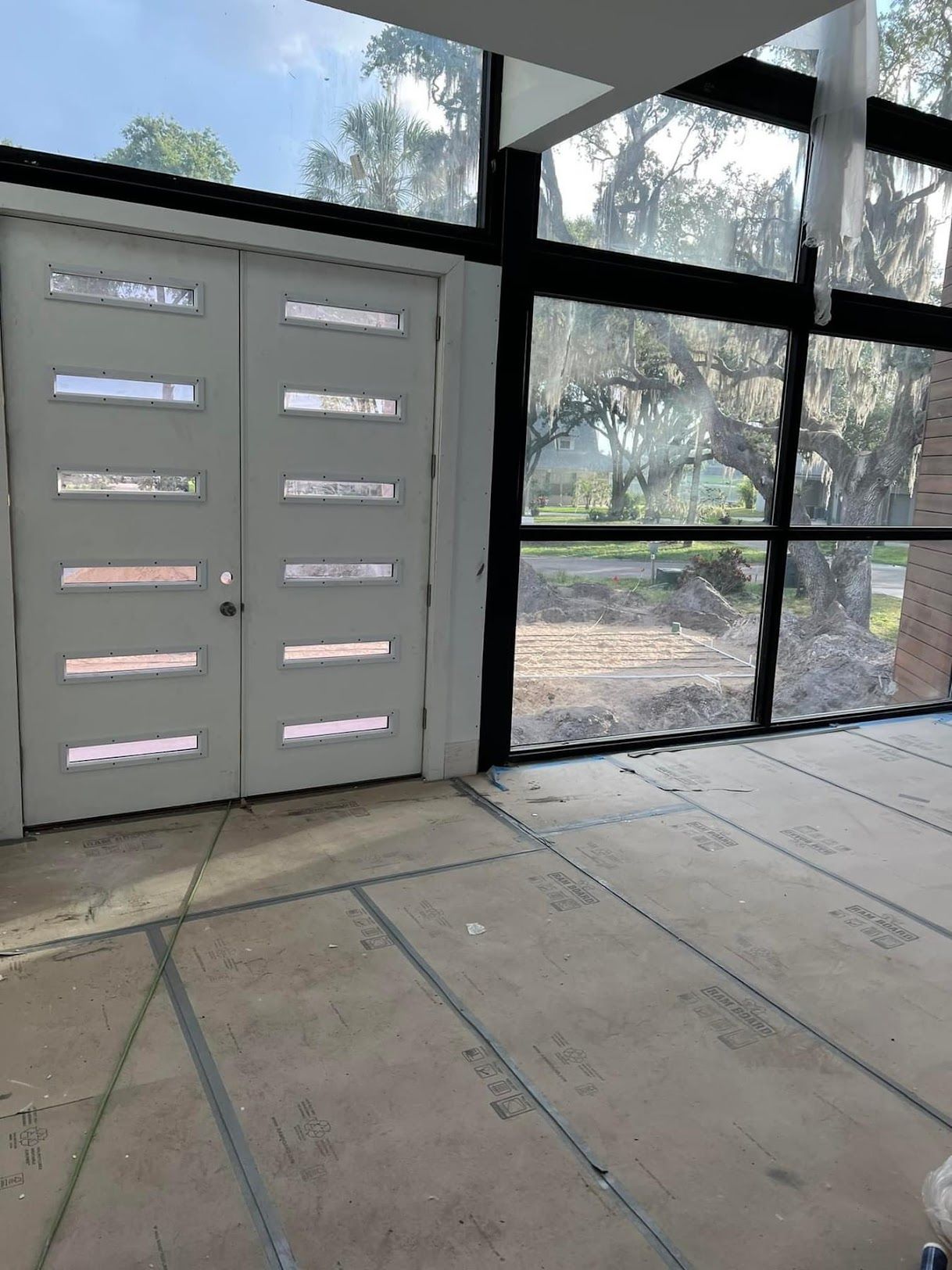 A room with a lot of windows and a door.