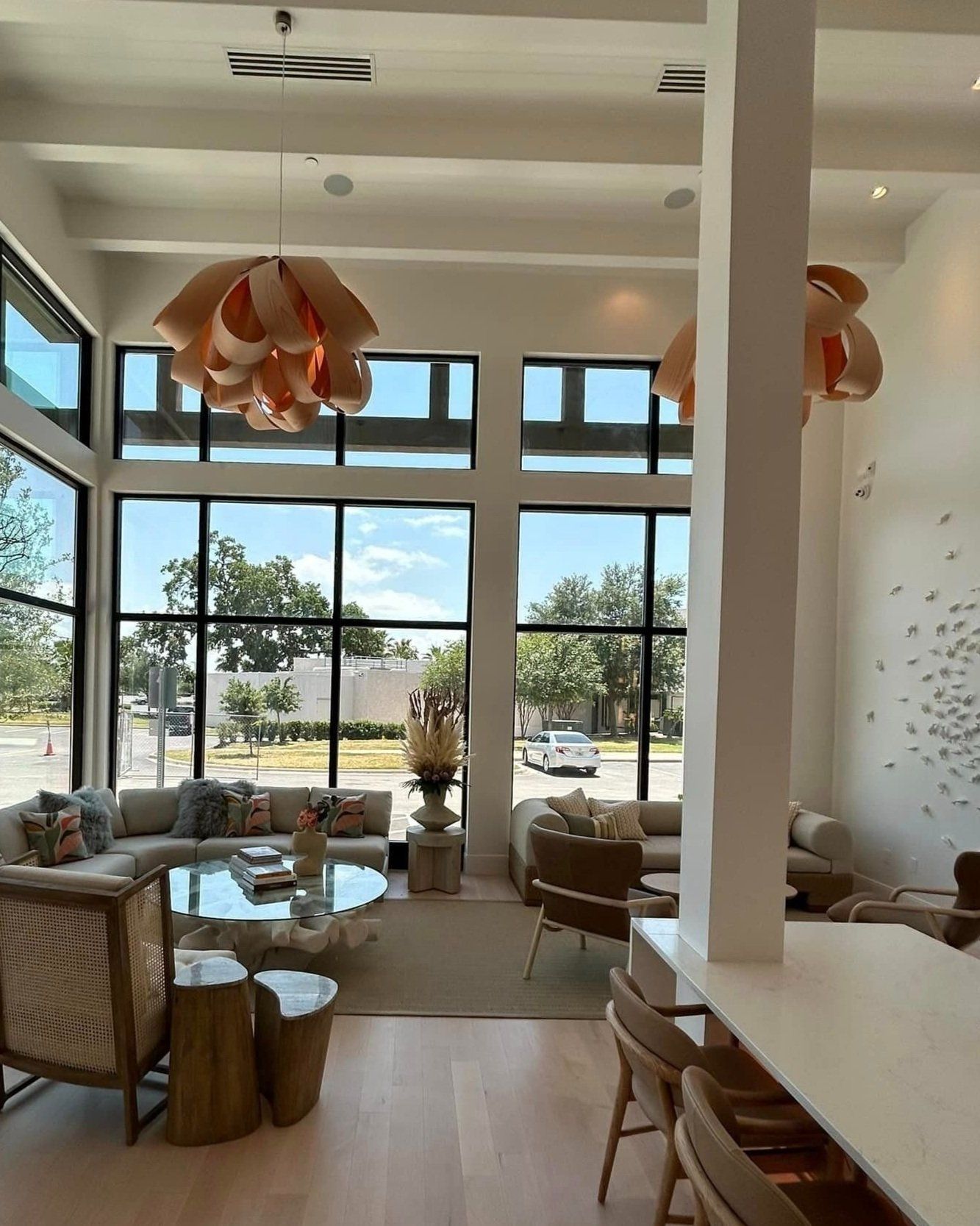 A living room with a lot of windows and furniture