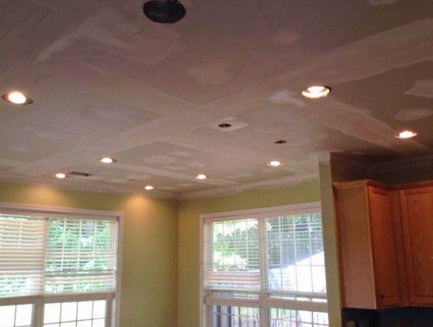 A room with a lot of windows and a white ceiling