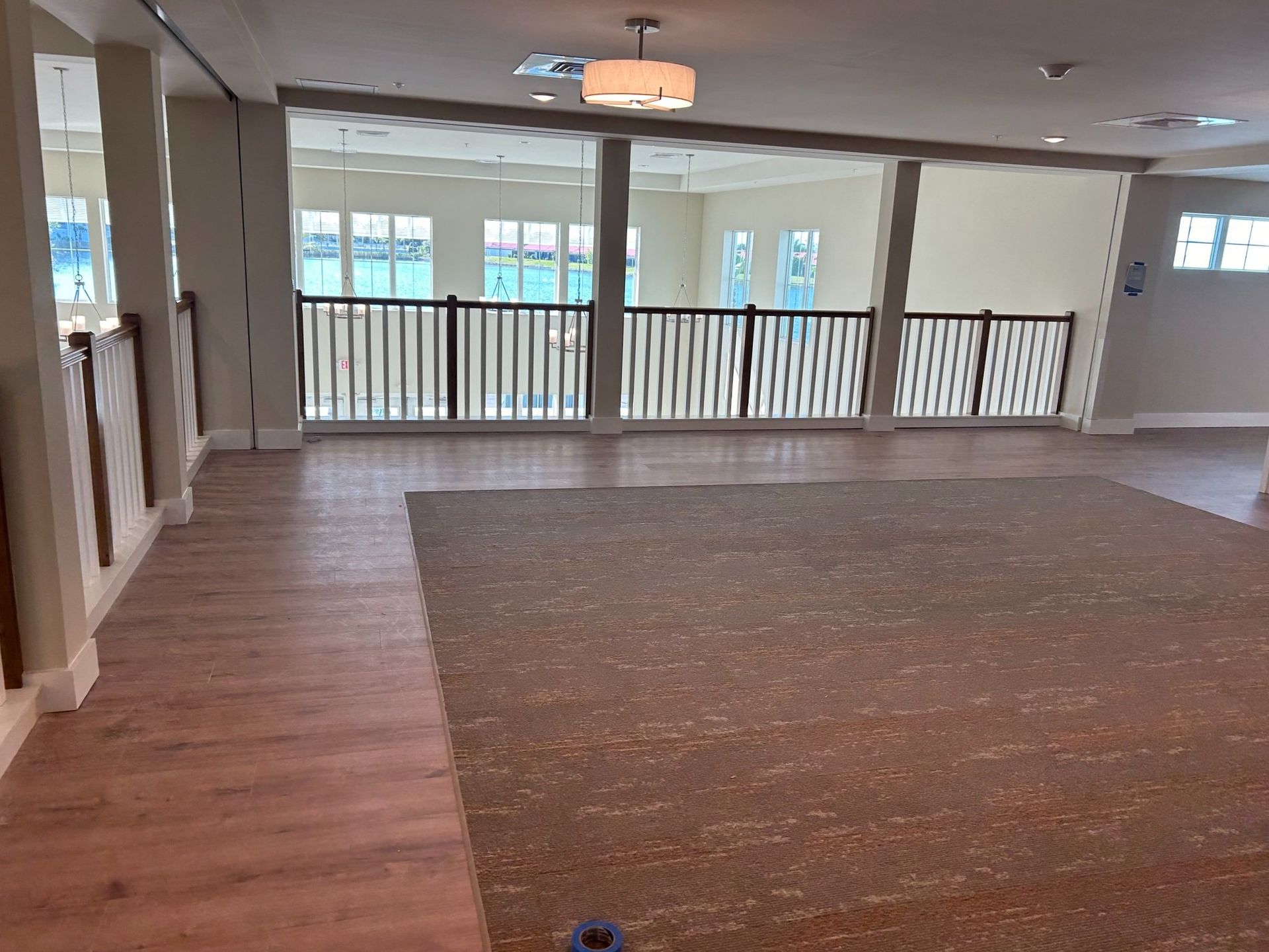 An empty room with hardwood floors and a rug
