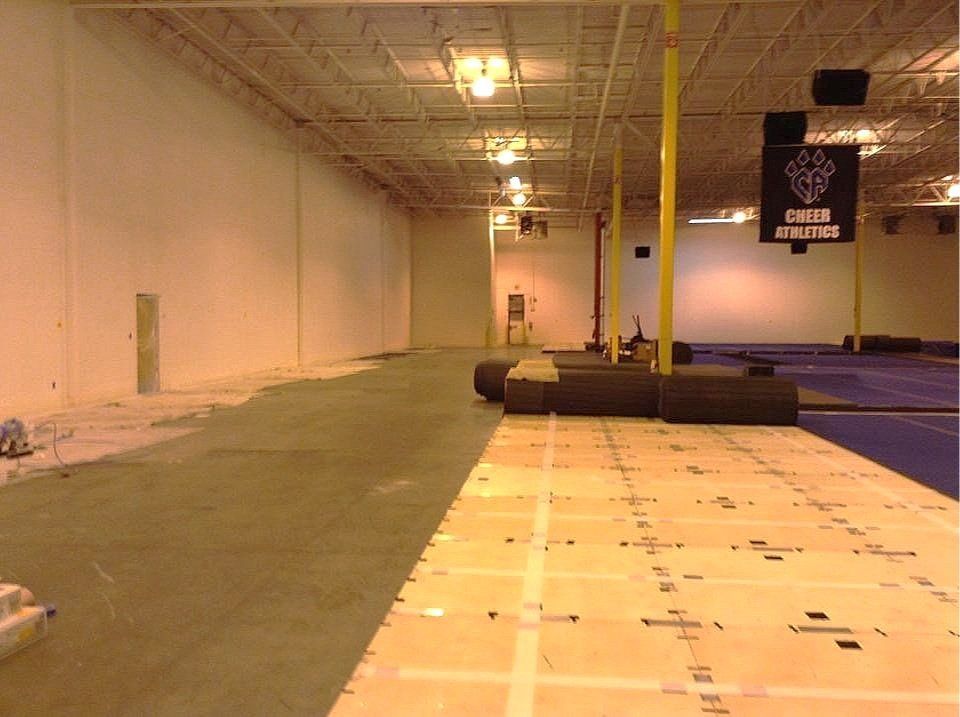 An empty gym with a sign that says chris athletics