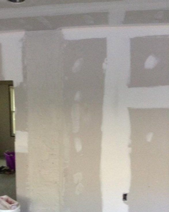 A room with a lot of drywall on the walls.