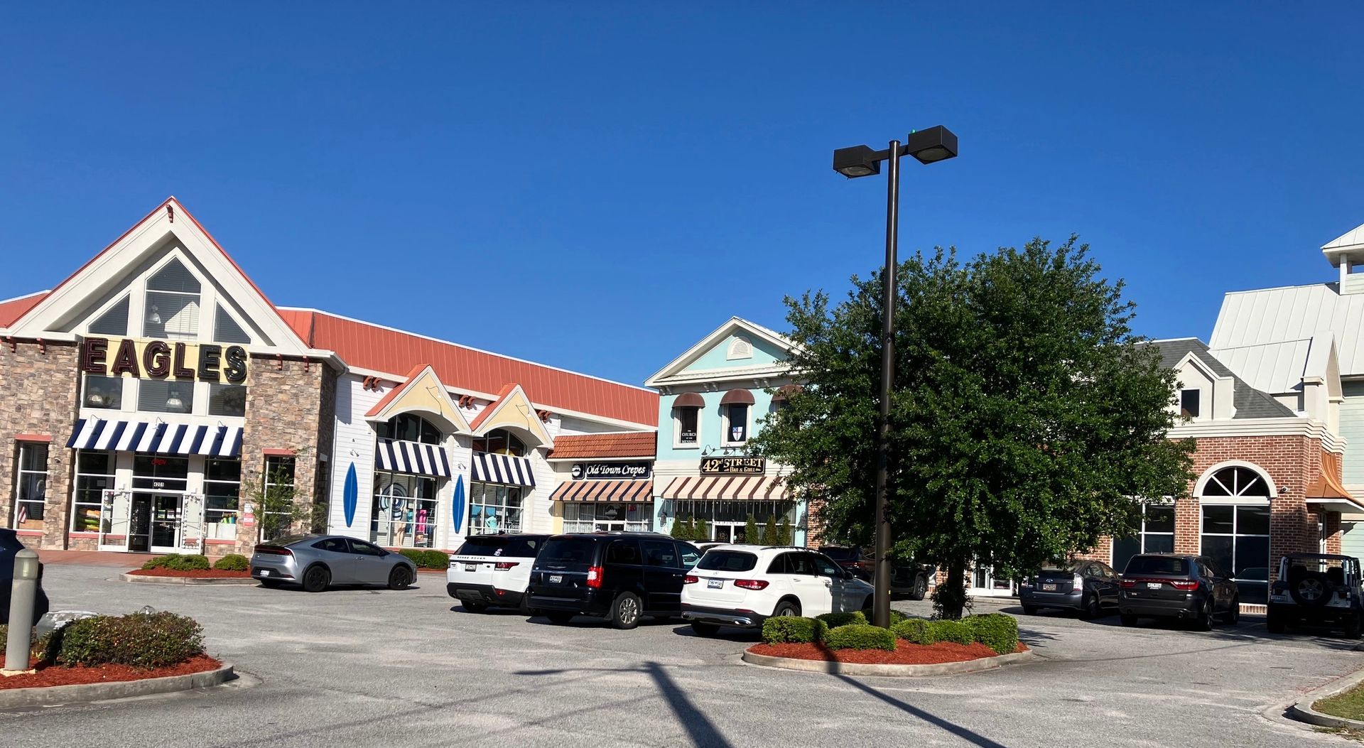 View of the shopping center as you enter the parking lot from the north. Church entrance is hidden from view on the north (right) side.