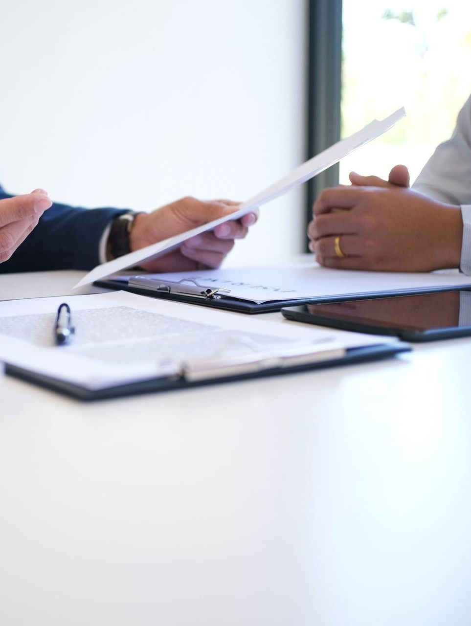 Two people are sitting at a table looking at a piece of paper.