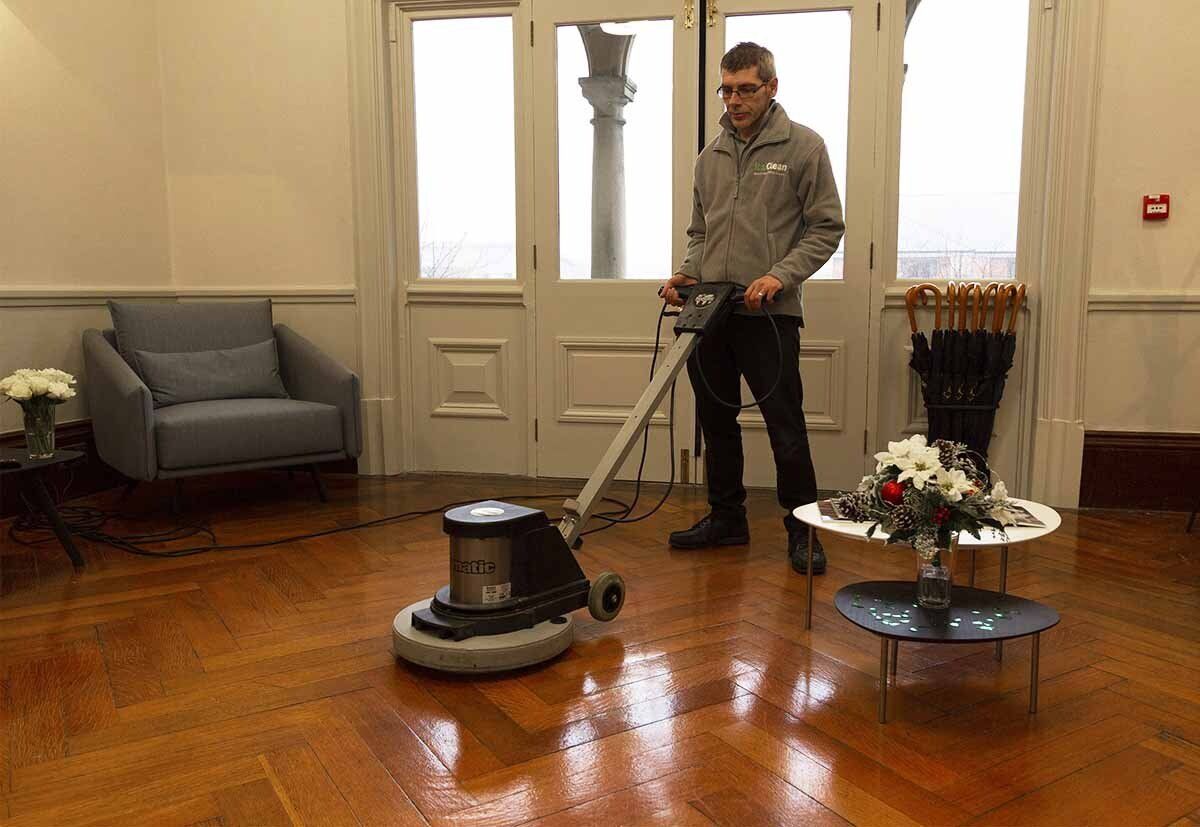 Cleaner buffing floor in office reception