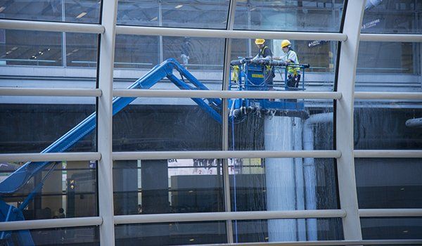 Office window cleaning from powered access platform