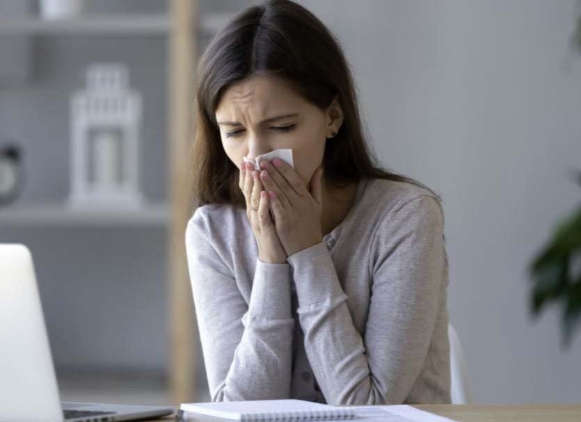 A woman sneezing