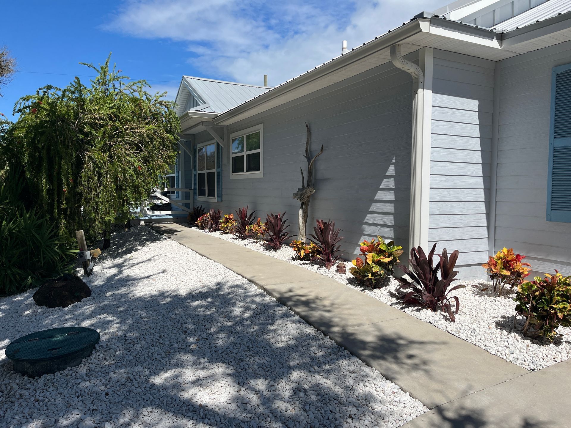 A white house with a walkway leading to it