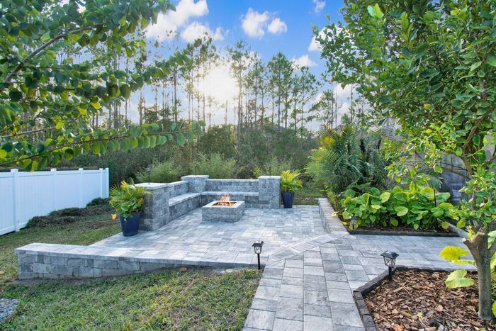 There is a fire pit in the middle of the backyard.
