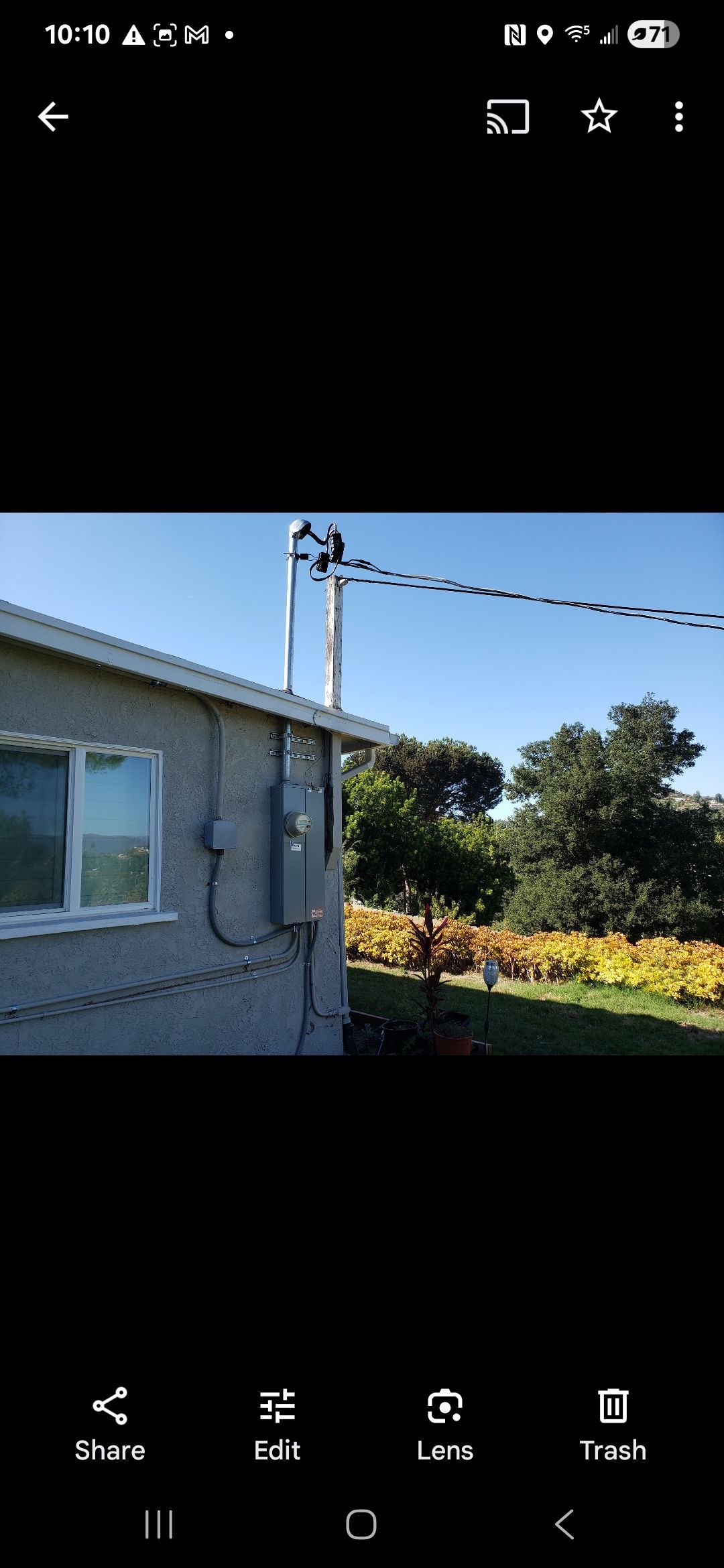A picture of a house with a telephone pole in the background.