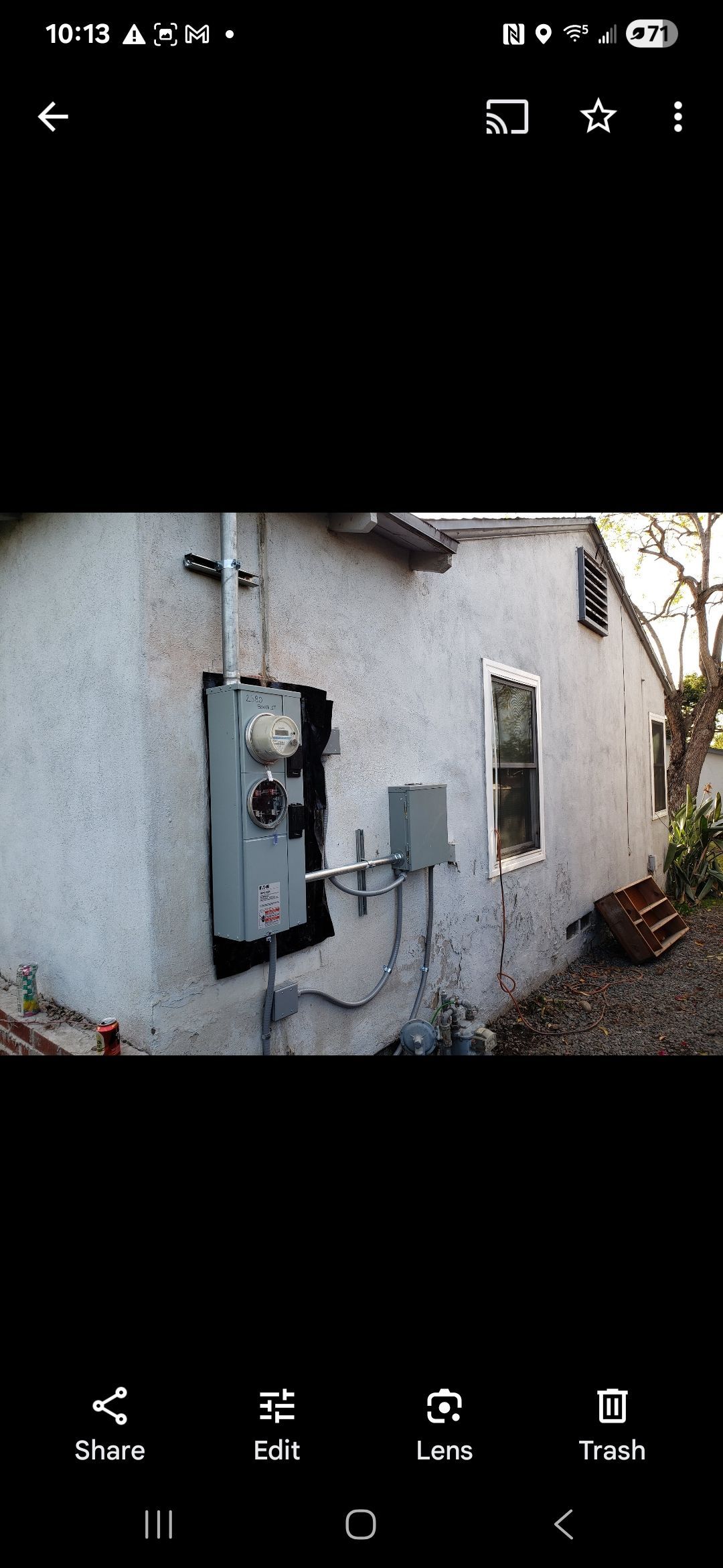 A picture of a house with a box on the side of it.