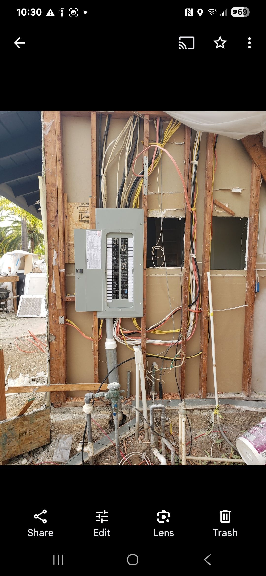 A picture of a house under construction on a cell phone.
