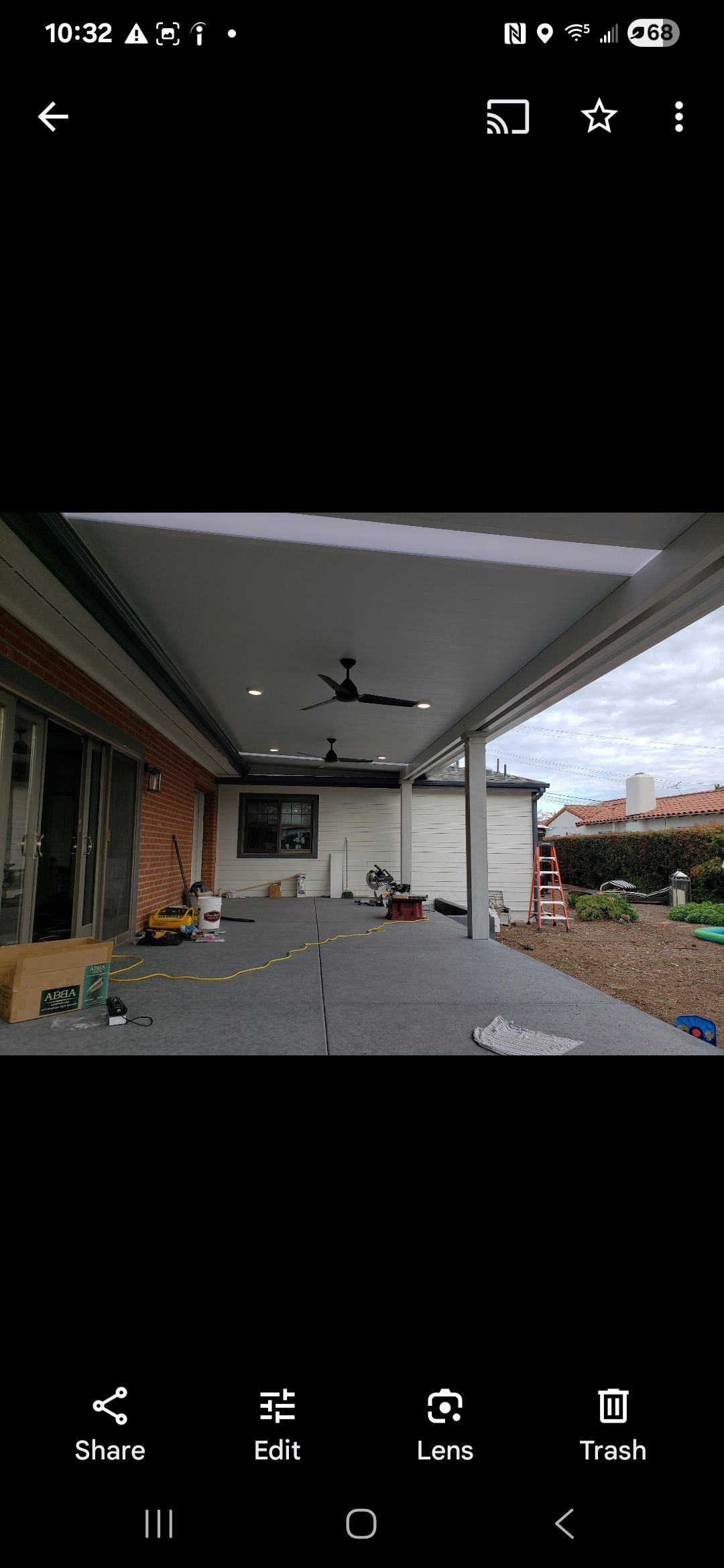A picture of a patio with a ceiling fan on a phone.