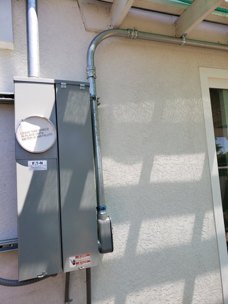 There is a meter on the side of a building.