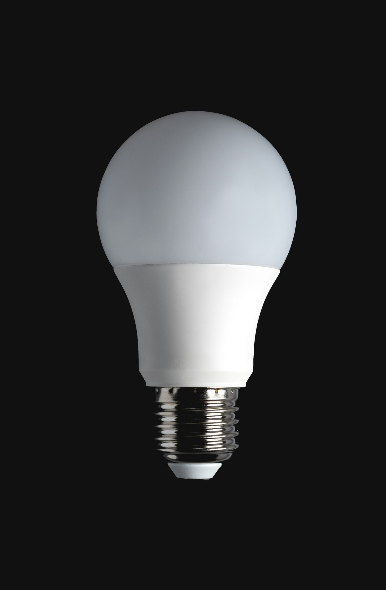 LED light bulb with white bulb and white base on a black background.