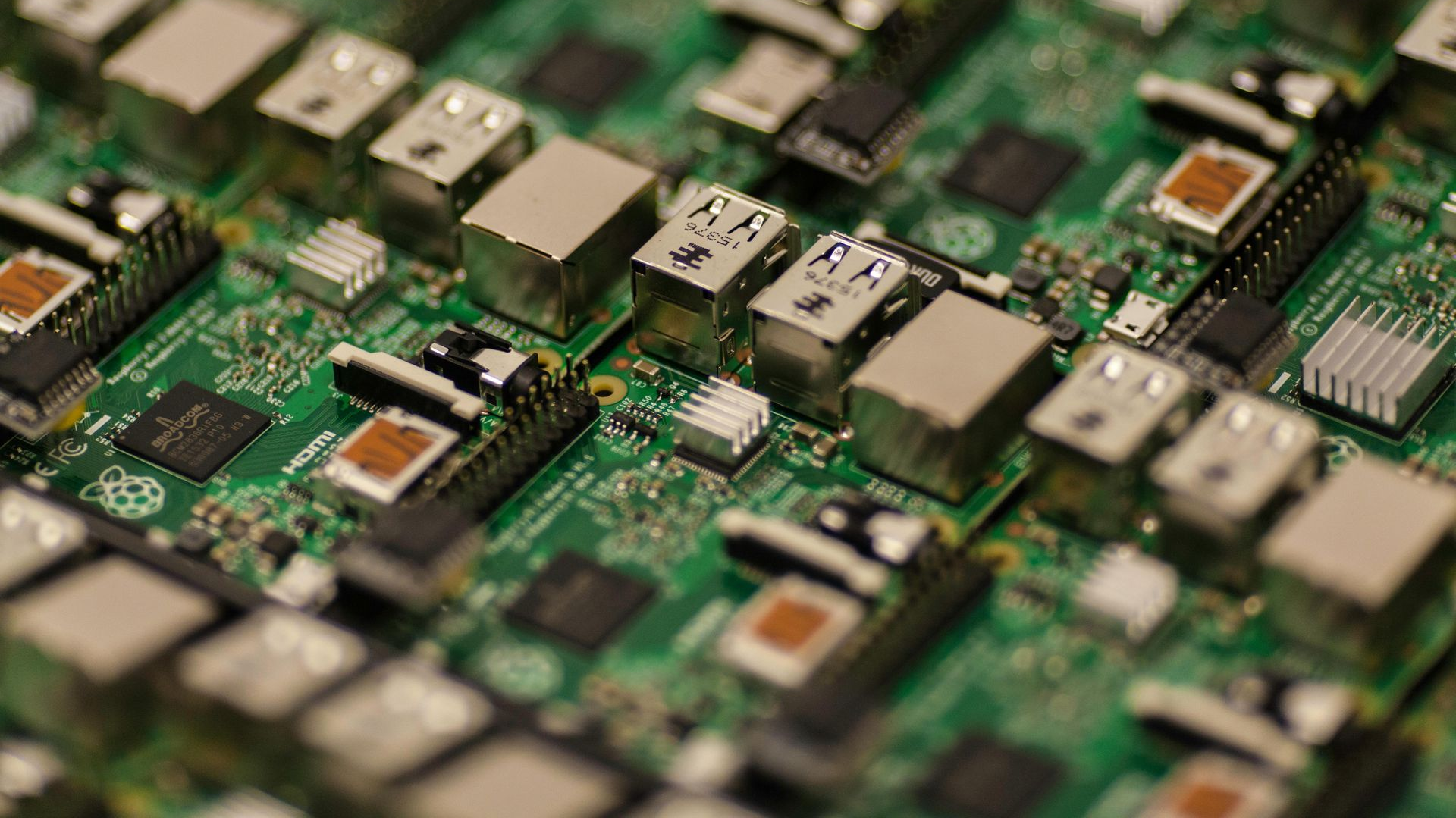 Close-up of a green circuit board densely populated with electronic components and connectors.