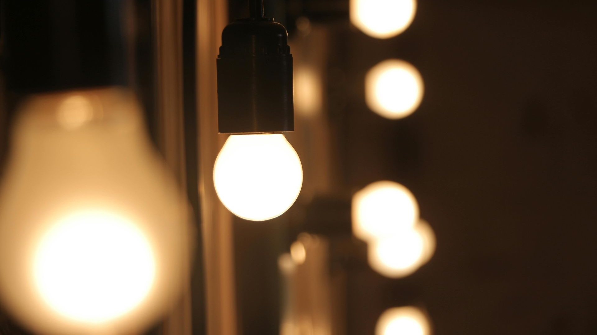 String of glowing light bulbs in a dim setting.