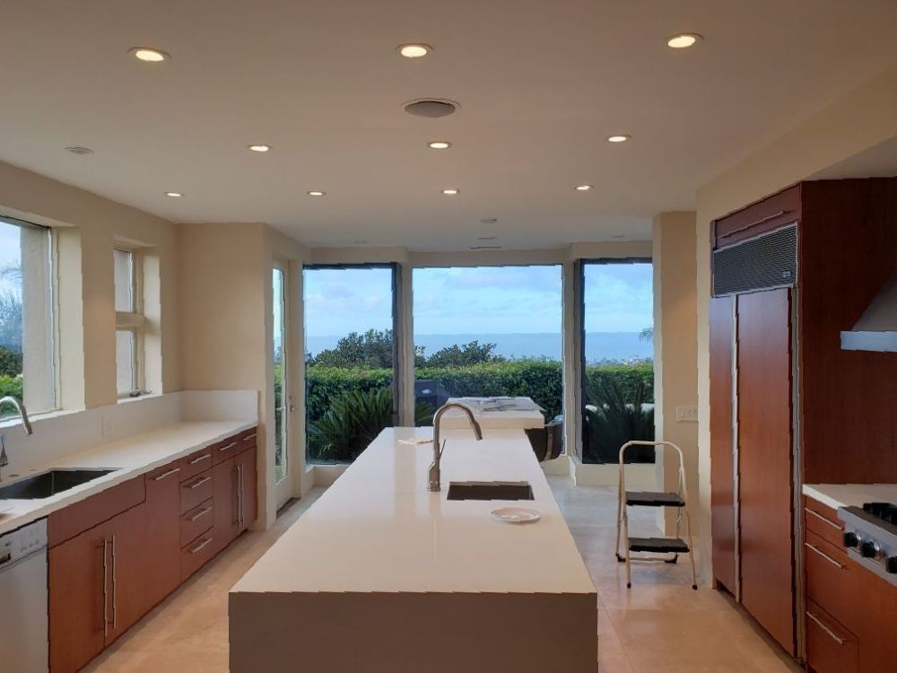 A kitchen with a large island and a view of the ocean