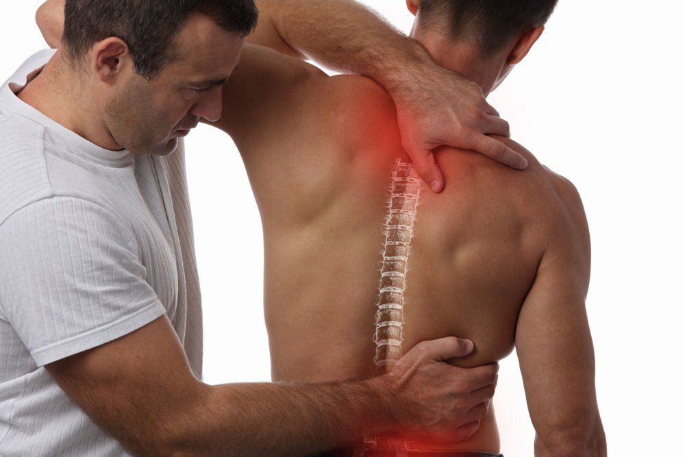 Man Having Physiotherapy Back Adjustment — PhysioCare Townsville In Thuringowa Central, QLD