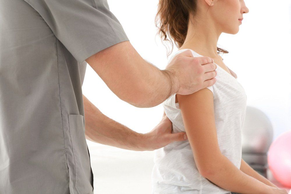 Physiotherapist Working With Patient in Backpain in Clinic, Closeup — PhysioCare Townsville In Thuringowa Central, QLD