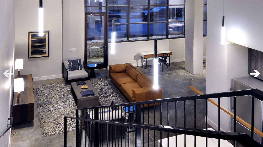An aerial view of a living room with a couch and chairs