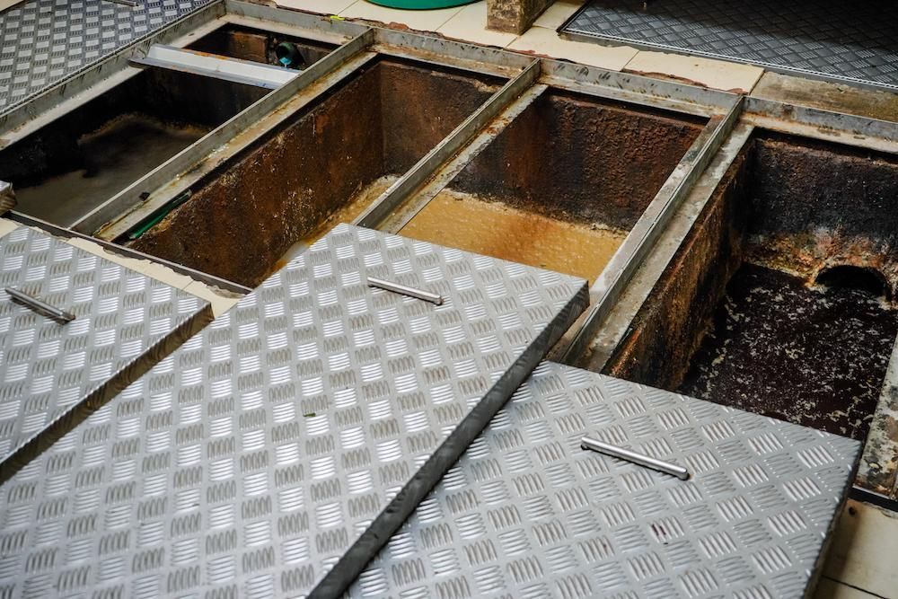 A Row of Metal Covers Sitting on Top of a Dirty Sink — Glenview Septic & Liquid Waste Removal In Caboolture, QLD